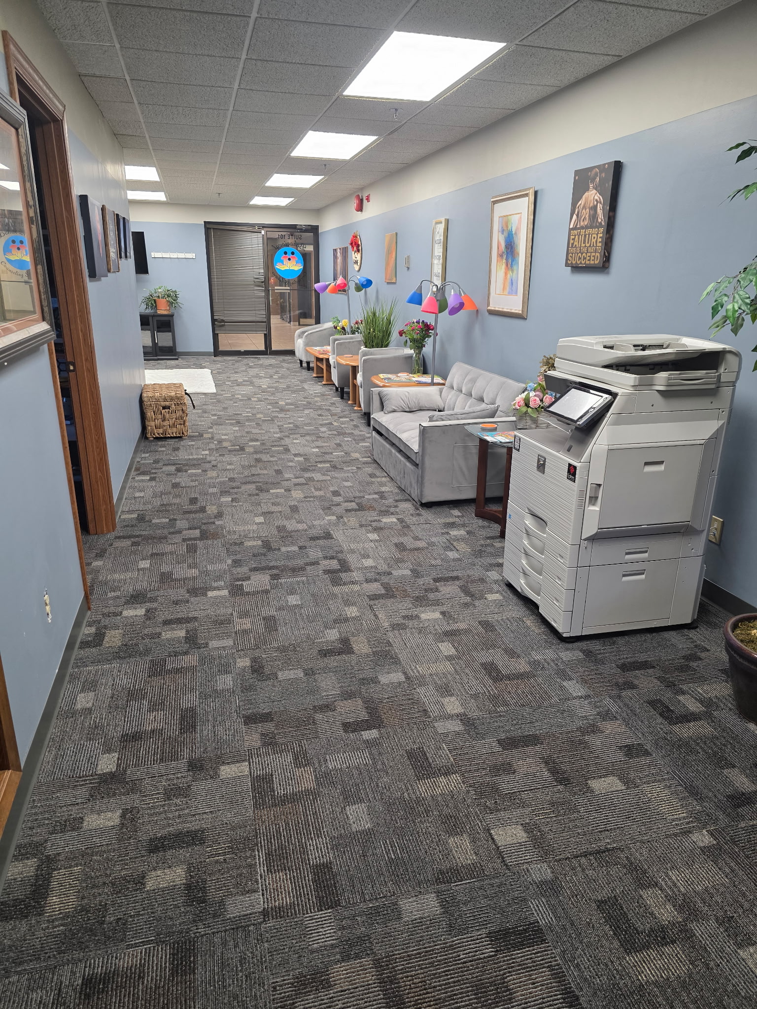 Reception hallway with comfortable seating and wall art